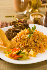 Biryani rice with traditional items on background