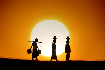 silhouette of traditional asian farmer coming back from a harves