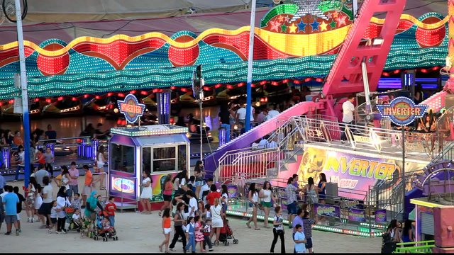 Fairground rides in an amusement park in the evening