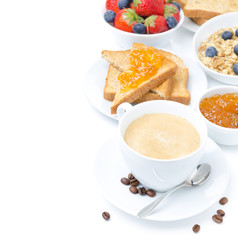 cup of cappuccino, toast with orange jam, berries and muesli