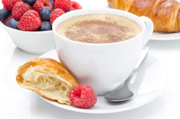 cup of coffee, croissant and fresh raspberry for breakfast