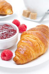delicious breakfast - fresh croissant, jam and raspberry