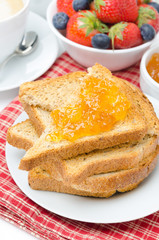 toast with orange jam and fresh berries for breakfast