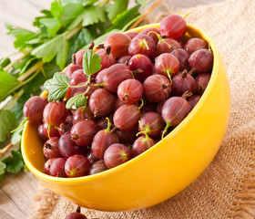 red gooseberries in a yellow bowl