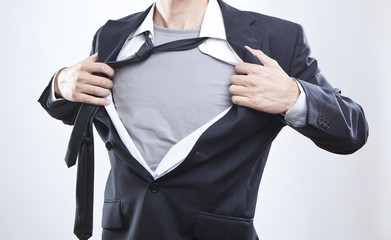 Closeup of a businessman showing the superhero suit under his sh