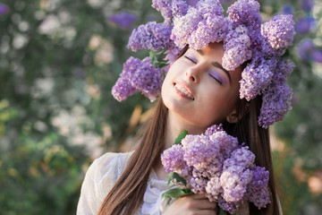 Fashion young woman with lilac flowers
