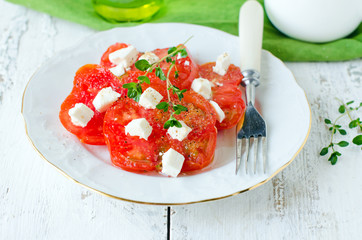 Salad from fresh tomatoes and cheese Fett with thyme