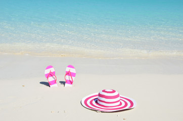 Flip-flops and hat on the beach