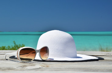 Hat and sunglasses on the beach of Exuma, Bahamas