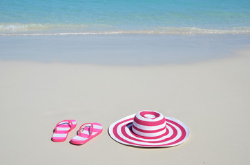 Flip-flops and hat on the beach