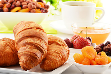 Breakfast with croissants cup of coffee and fruits