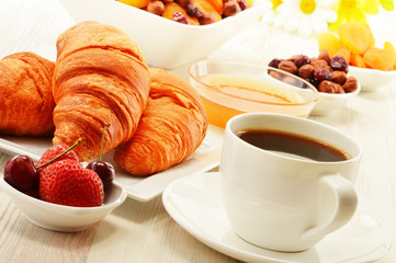 Breakfast with croissants cup of coffee and fruits