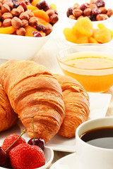 Breakfast with croissants cup of coffee and fruits