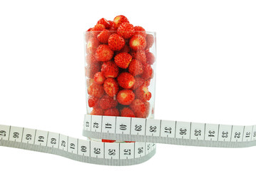 poziomki w szklance i metr na białym tle © slawek_zelasko