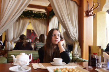 Thinking teen in the restaurant