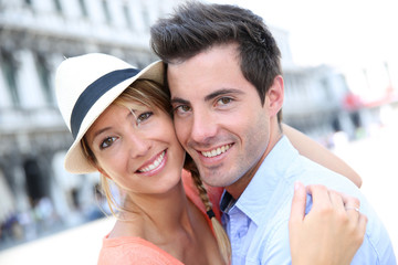 Smiling couple standing in San Marco Place, Venice