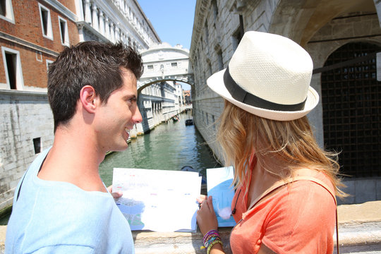 Couple looking at map by the Bridge of Sighs, Venice