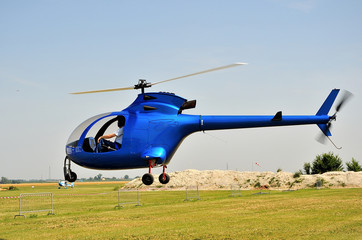 blue helicopter on take off