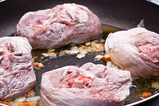 floured osso buco in pan