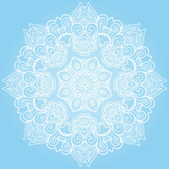 Round lace ornament isolated on blue.
