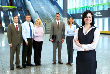 Obraz premium Business woman and a group of workers.
