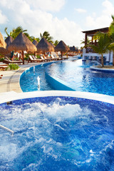 Jacuzzi and a swimming pool at caribbean resort.
