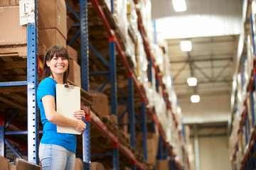 Obraz premium Female Worker In Distribution Warehouse