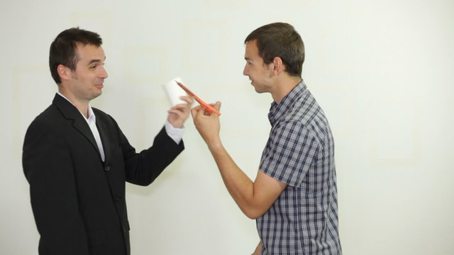 Two funny businessmen playing rock-paper-scissors