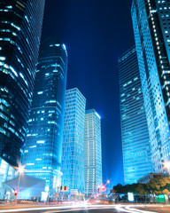 Dreamy blue modern office buildings at night in Shanghai