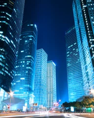 Schilderijen op glas Dreamy blue modern office buildings at night in Shanghai © Aania