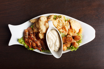 Image of hearty fish snacks served with sauce