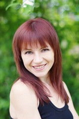 Naklejka premium portrait of beautiful smiling woman outdoors