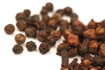 Black Pepper Corns and Cloves on white background