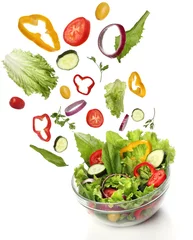 Fotobehang Falling fresh vegetables. Healthy salad isolated © Julián Rovagnati