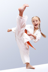 Professional girl does karate kick - obrazy, fototapety, plakaty