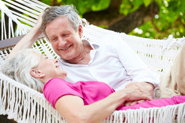 Senior Couple Relaxing In Beach Hammock
