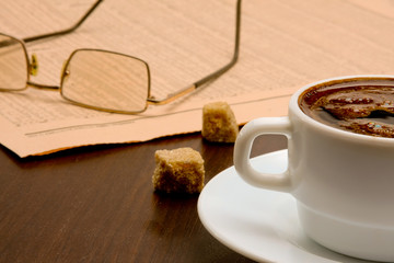 Cup of coffee and newspaper