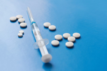 Filled syringe and pills