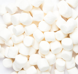 A pile of small white puffy marshmallows on white background. Cl