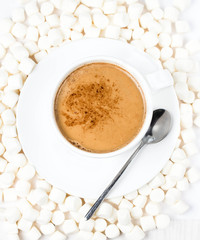 Cup of hot cocoa  with chocolate and marchmallows on white backg
