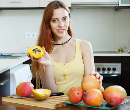  Woman Eating Mango At Home Kitchen