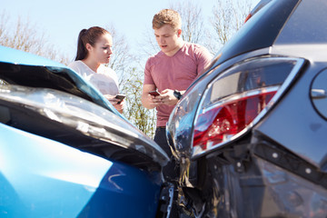 Two Drivers Exchange Insurance Details After Accident