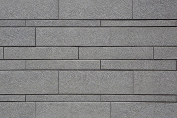 Muro grigio di mattoni irregolari