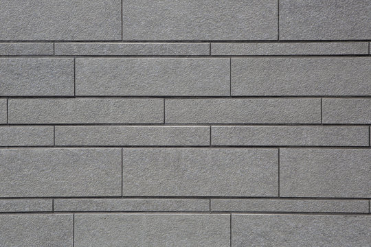 Muro grigio di mattoni irregolari
