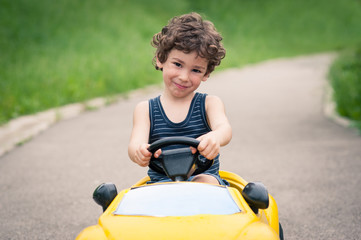 Young kid close up portrait with toy car outdoors. © pio3