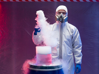 chemist experimenting with vapors on blue barrel