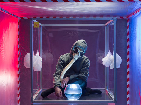 person confined inside a glass box