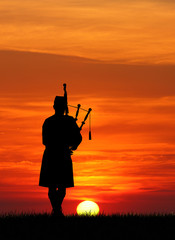 man plays the bagpipes