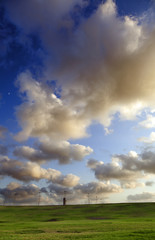 Fototapeta premium Grassy Hills under Dramatic Sky