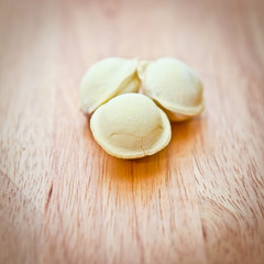 Fototapeta na wymiar three dumplings on a wooden board, close-up
